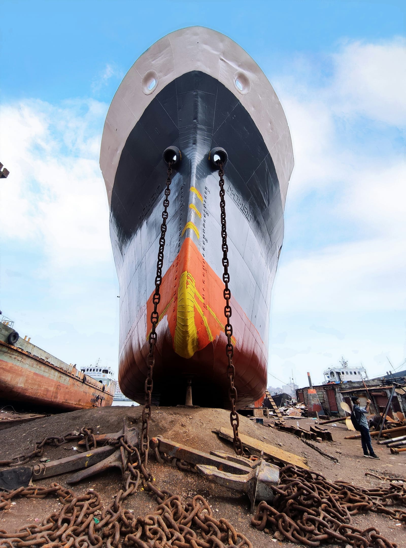 Ship bow in drydock with anchor chains
